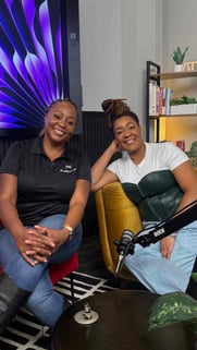 Host Mellanda Reese and Asia Noel smiling in a modern podcast studio, preparing for a deep dive into 2026 Atlanta business certifications.